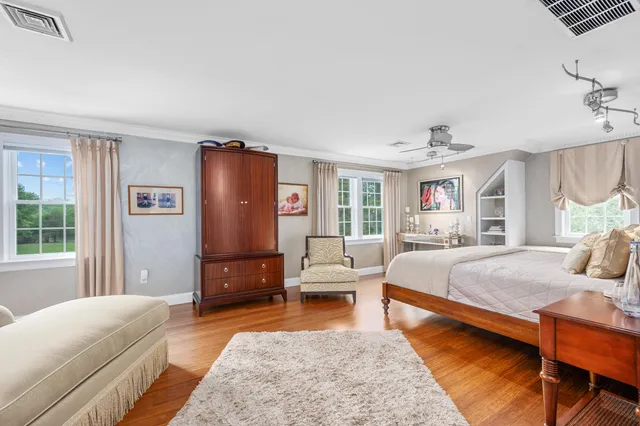 a bedroom with a large bed and a chandelier