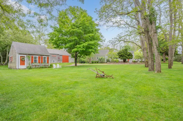 a living room with furniture a flat screen tv and a large window