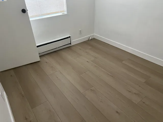an empty room with wooden floor