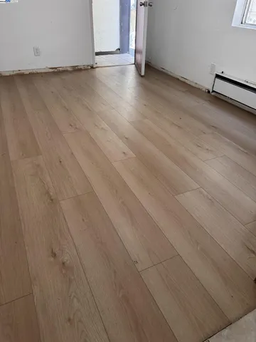 a view of a room with wooden floor