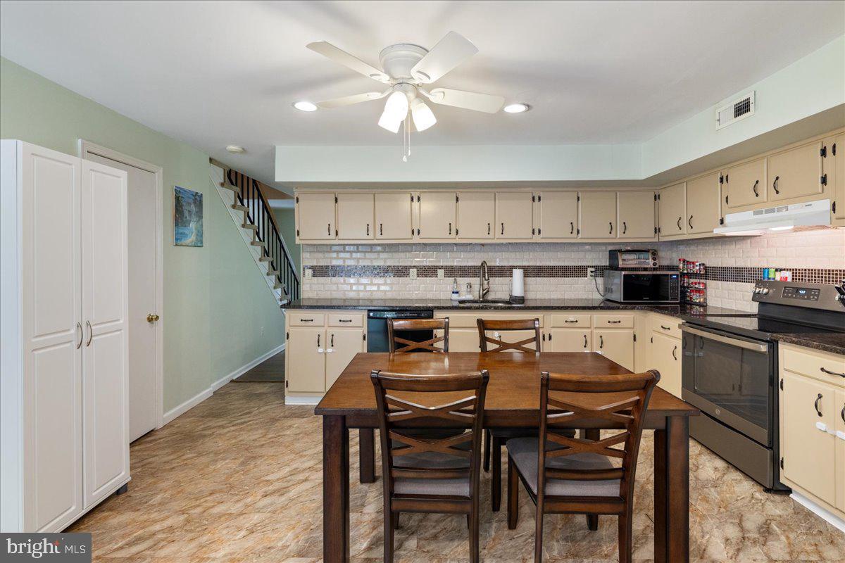 4639 Sands Way Doylestown, PA 18902 - Photo 13 of 32 a kitchen with a table chairs stove and cabinets