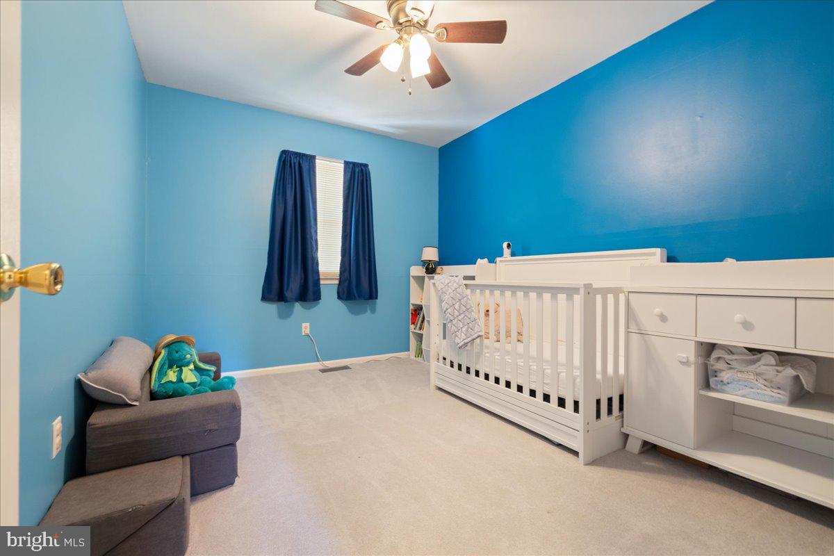 4639 Sands Way Doylestown, PA 18902 - Photo 18 of 32 a bed room with a bed and a chandelier