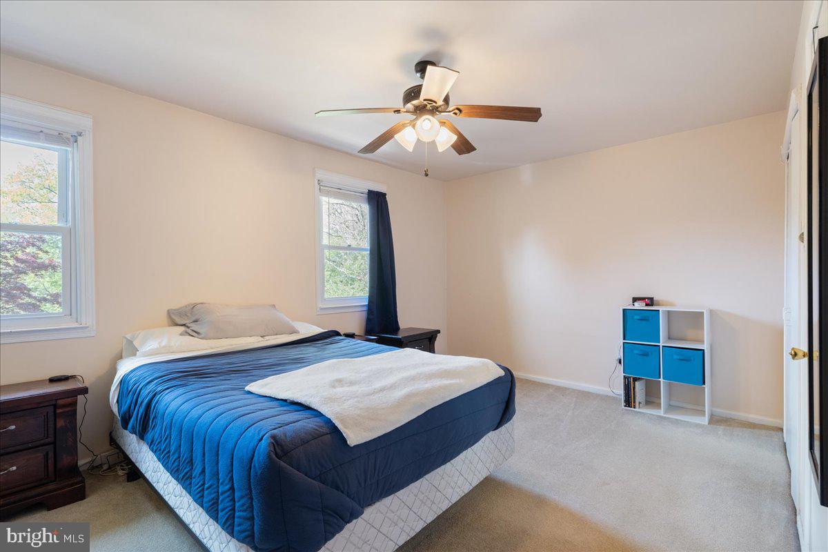 4639 Sands Way Doylestown, PA 18902 - Photo 24 of 32 a bedroom with a bed and a chandelier