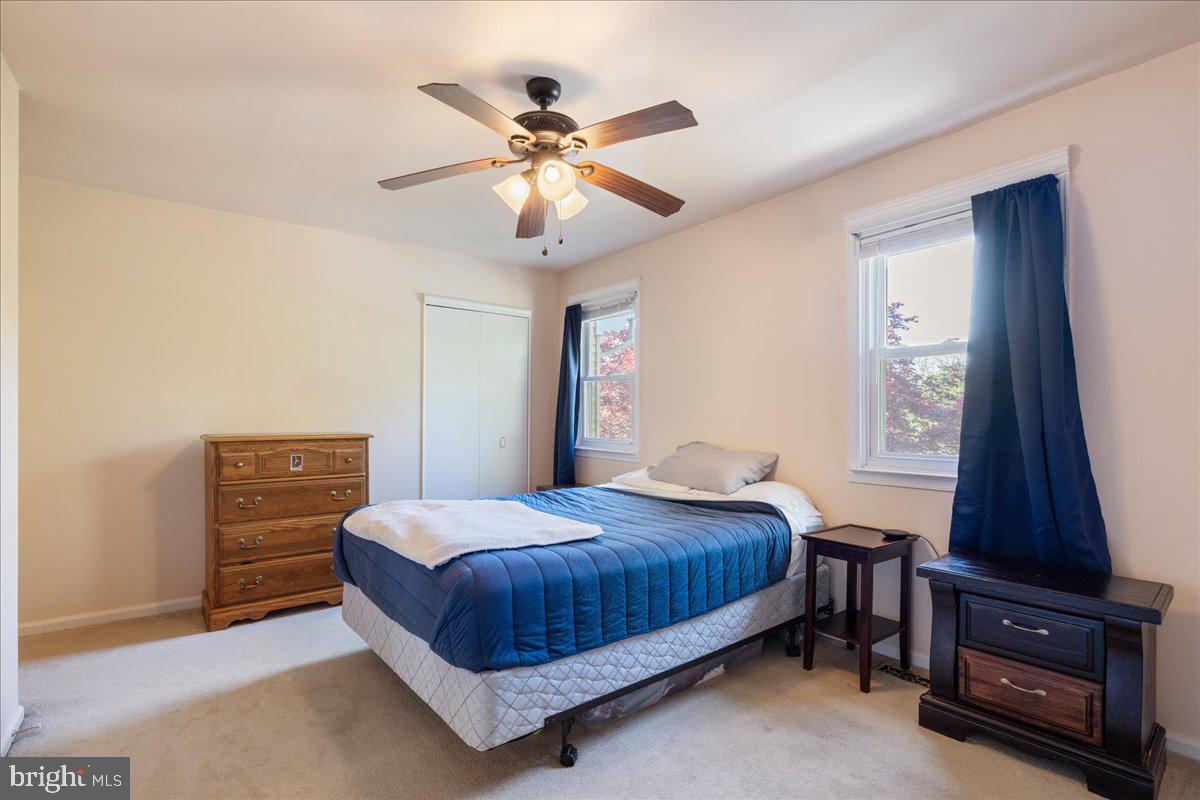 4639 Sands Way Doylestown, PA 18902 - Photo 25 of 32 a bedroom with a bed and a flat tv screen on a dresser
