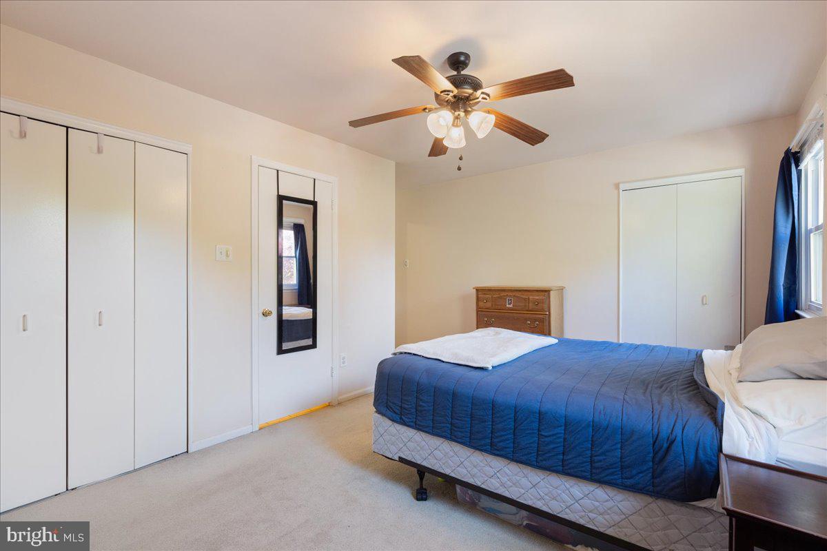 4639 Sands Way Doylestown, PA 18902 - Photo 26 of 32 a bedroom with a bed and a chandelier