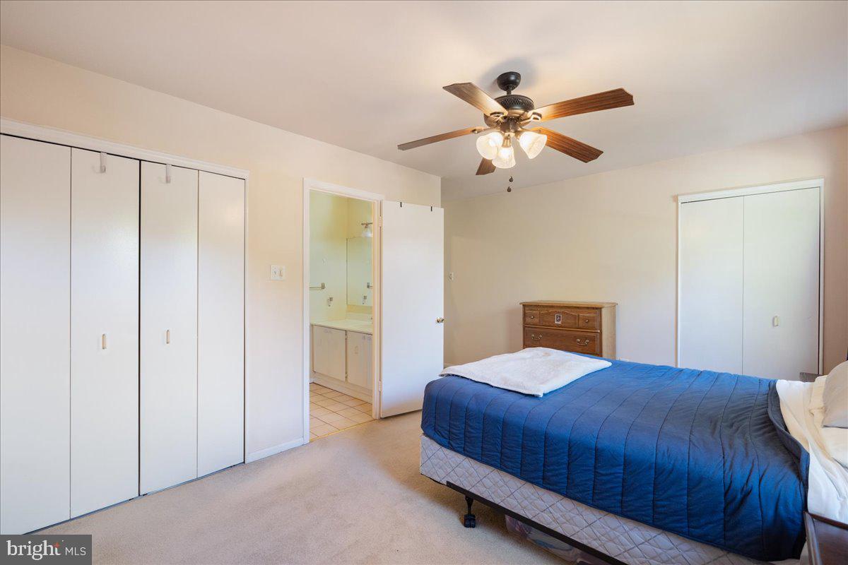 4639 Sands Way Doylestown, PA 18902 - Photo 27 of 32 a bedroom with a bed and a chandelier