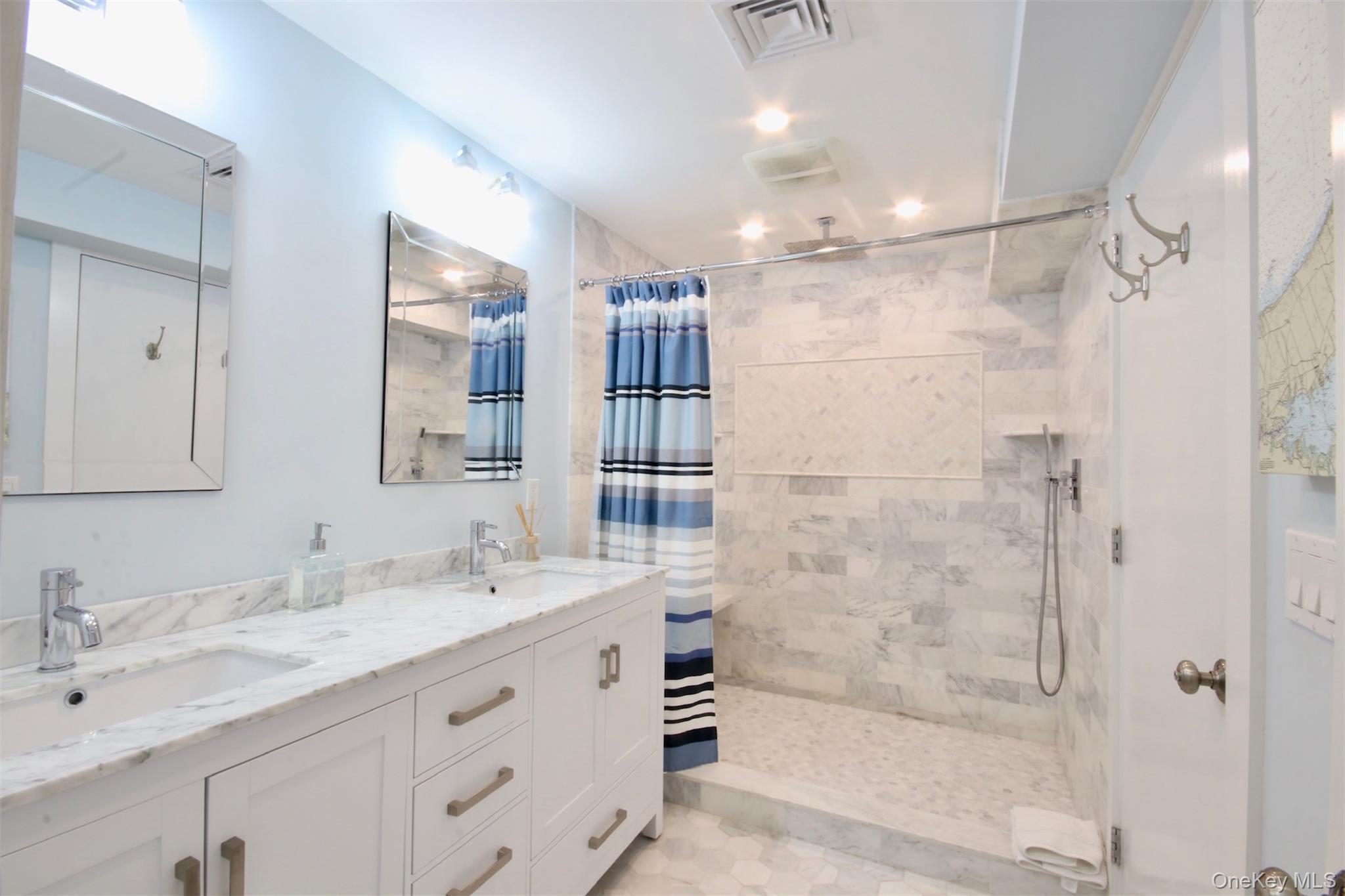 28 Old Trail Road Water Mill, NY 11976 - Photo 13 of 25 a bathroom with a granite countertop sink mirror and shower