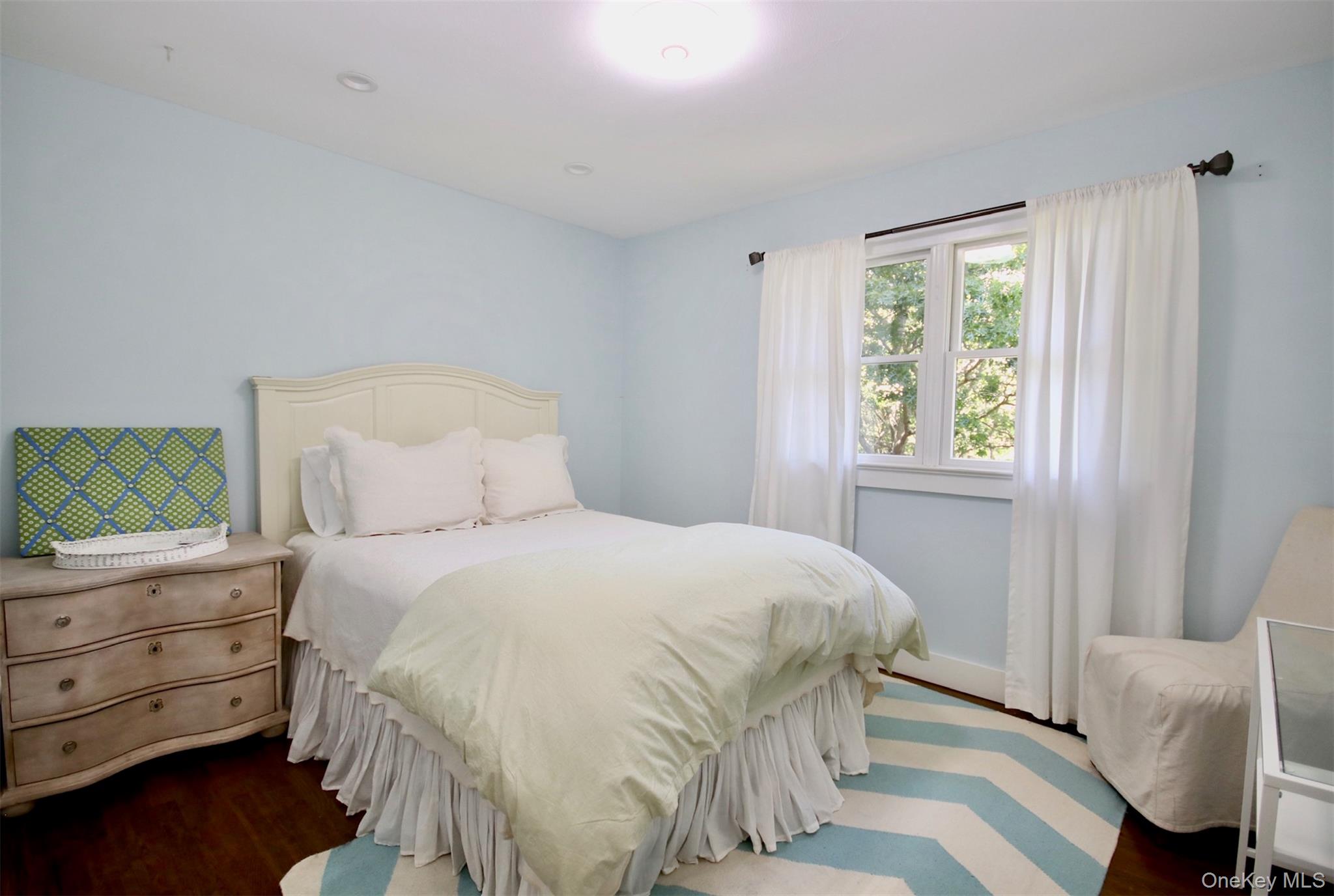 28 Old Trail Road Water Mill, NY 11976 - Photo 14 of 25 a bedroom with a bed and a window