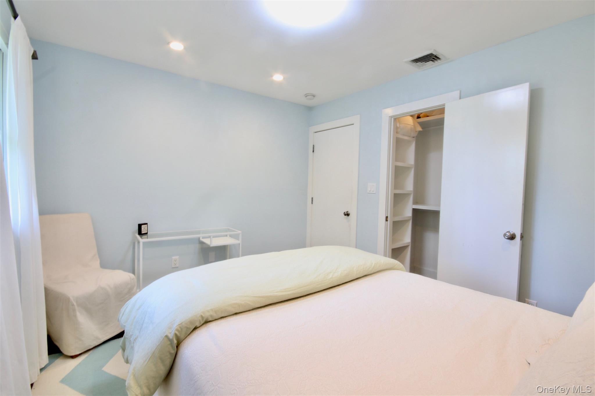 28 Old Trail Road Water Mill, NY 11976 - Photo 15 of 25 a bedroom with a bed and a chair