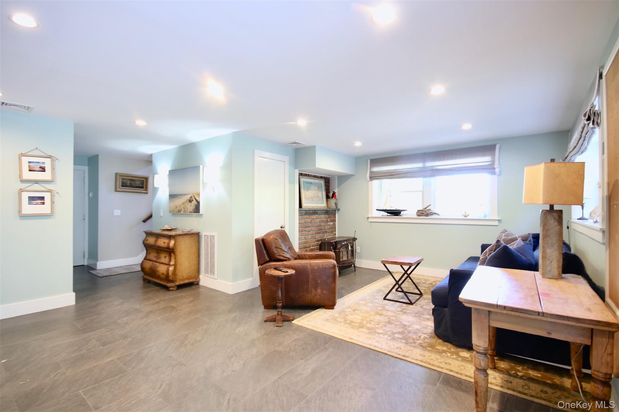 28 Old Trail Road Water Mill, NY 11976 - Photo 21 of 25 a living room with furniture and a flat screen tv