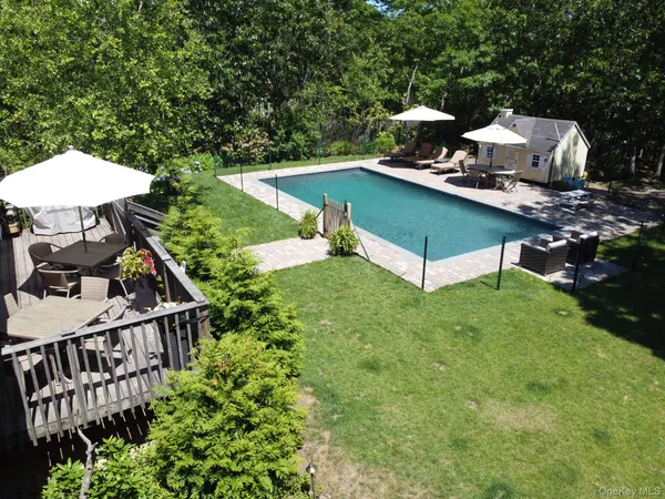 a view of a house with backyard entertaining space and deck