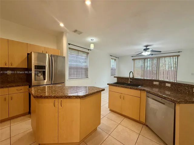 a kitchen with granite countertop a sink and cabinets