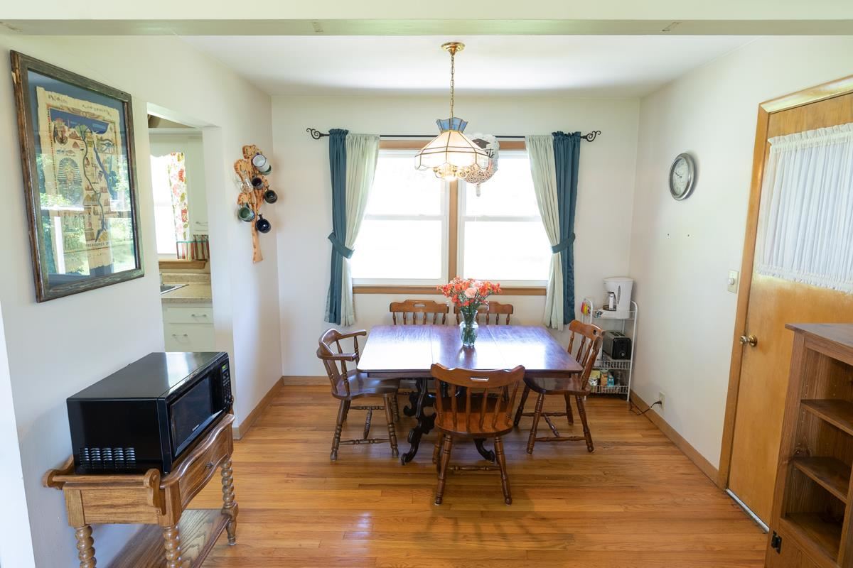 357 Phyllis Avenue Rochelle, IL 61068 - Photo 4 of 18 a dining room with furniture a chandelier and wooden floor