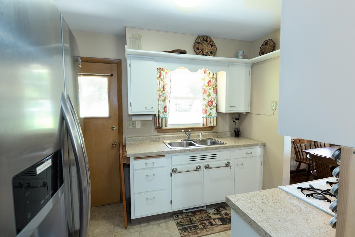 357 Phyllis Avenue Rochelle, IL 61068 - Photo 7 of 18 a kitchen with a sink a window and stainless steel appliances