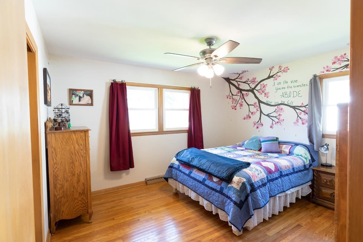 357 Phyllis Avenue Rochelle, IL 61068 - Photo 8 of 18 a bedroom with a bed and a chandelier