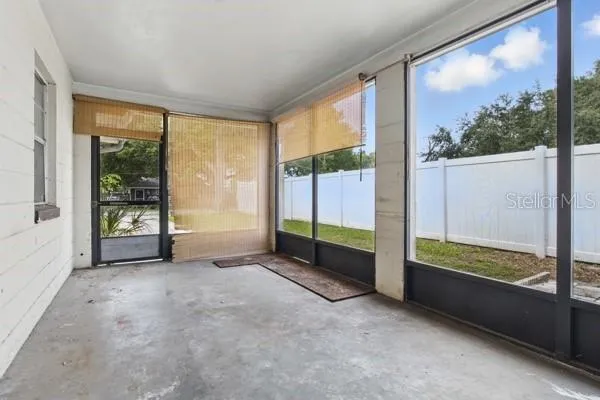 a view of an empty room with windows