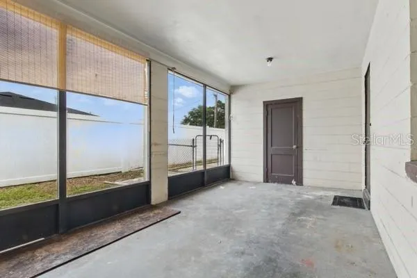 a view of an empty room with a window