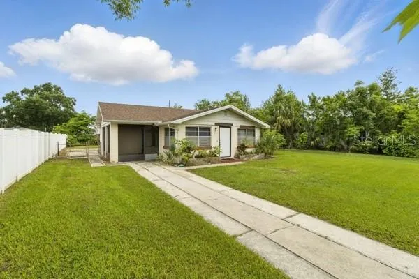 a front view of house with yard and green space