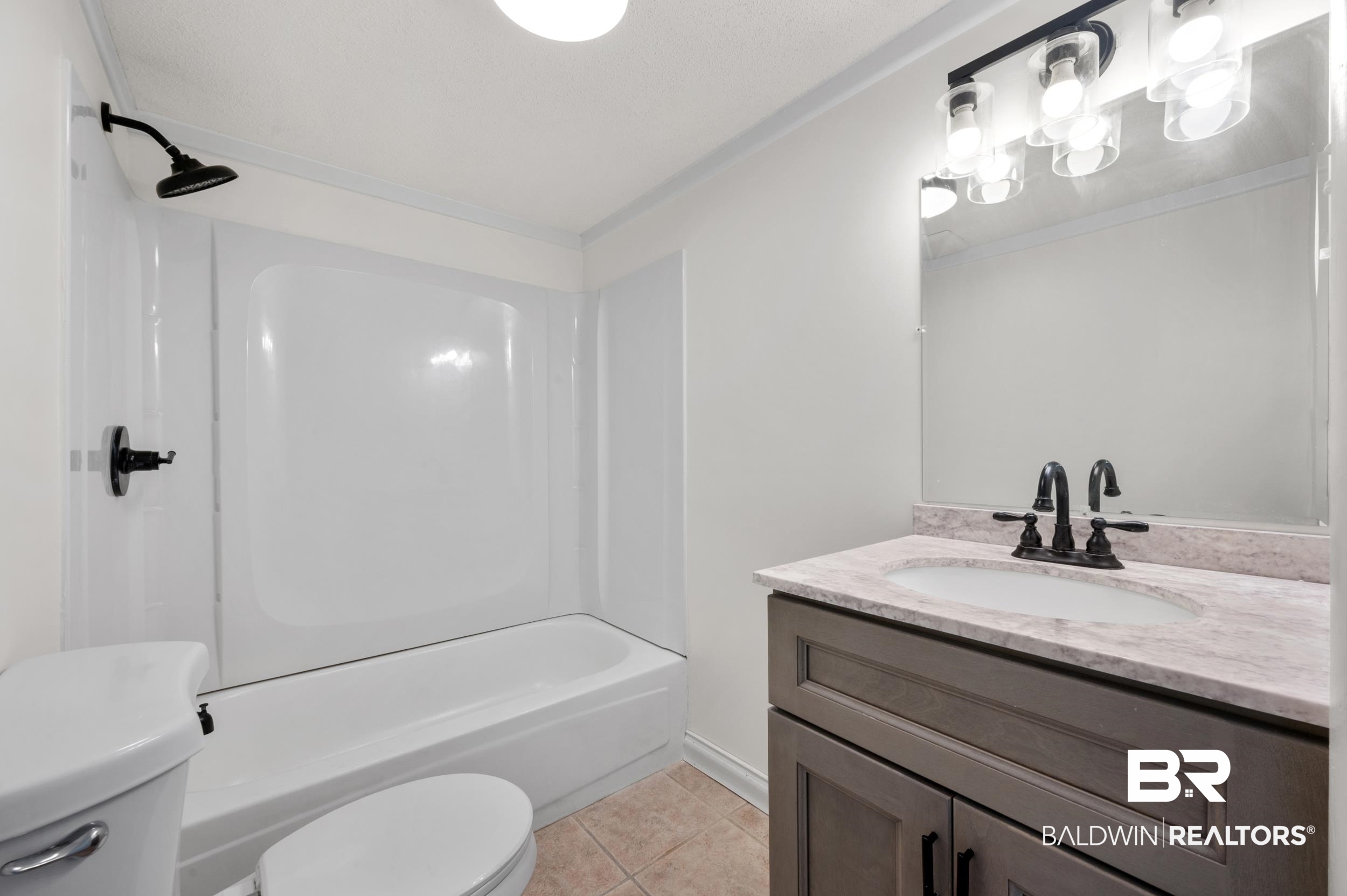 35780 Spring Road North Stapleton, AL 36578 - Photo 21 of 41 Full bathroom with vanity, light tile patterned floors, and shower / bath combination