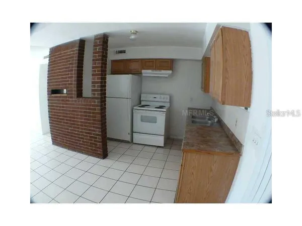 a kitchen with a refrigerator and a stove