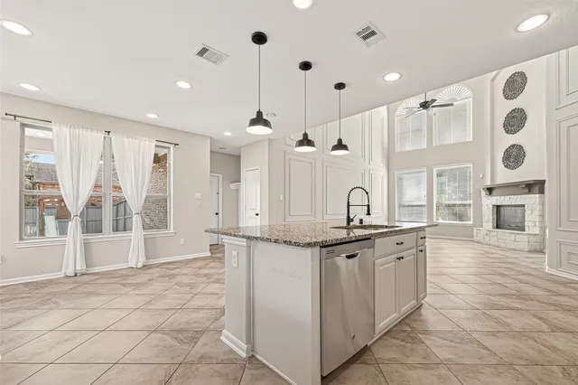 a kitchen with stainless steel appliances granite countertop a sink and cabinets