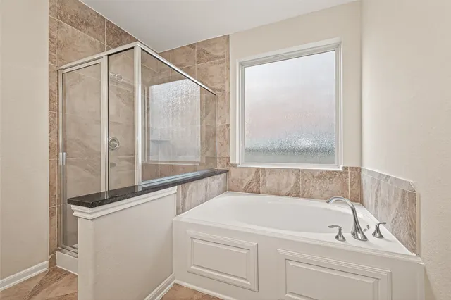 a bathroom with a tub and a shower