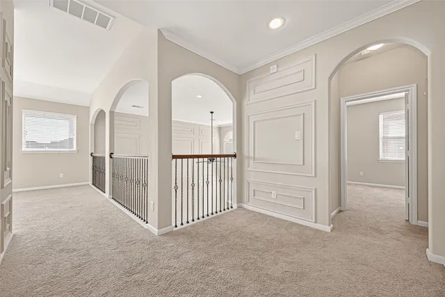 an empty room with windows and entryway