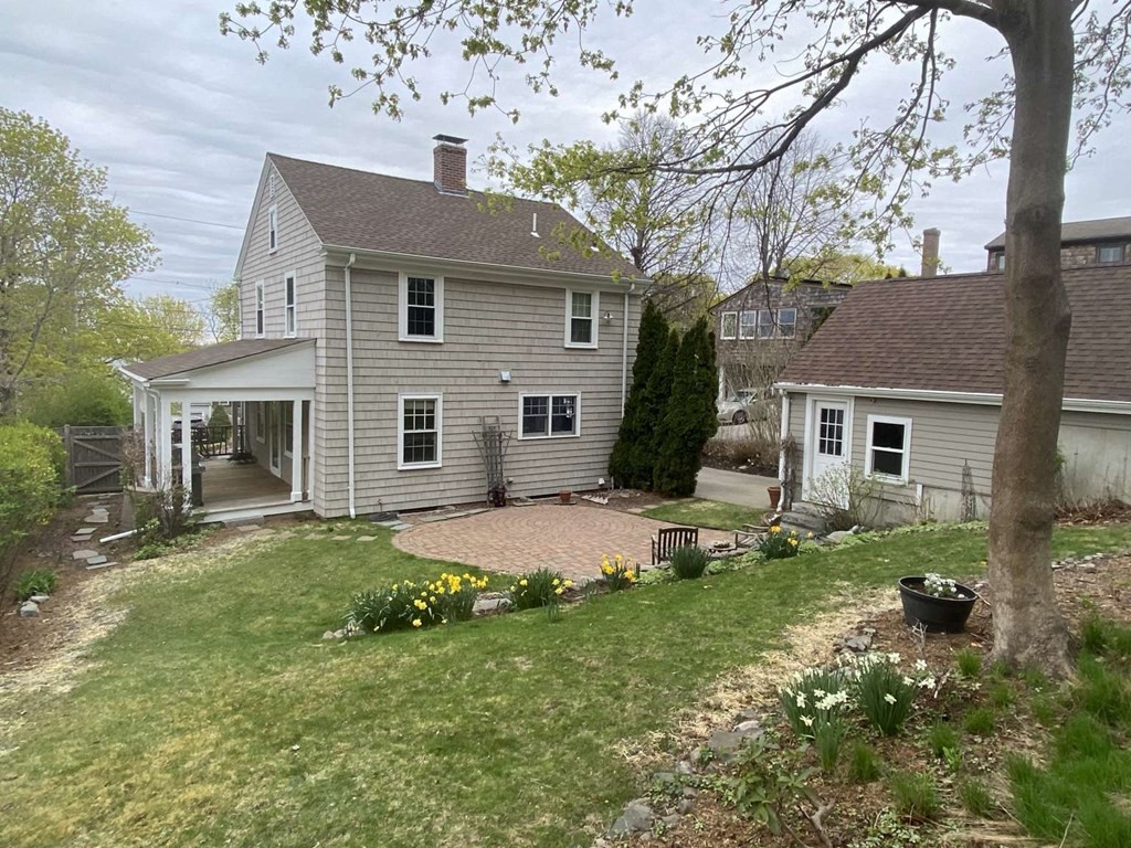 52 Governor Long Road Hingham, MA 02043 - Photo 2 of 19 a front view of a house with a garden and yard