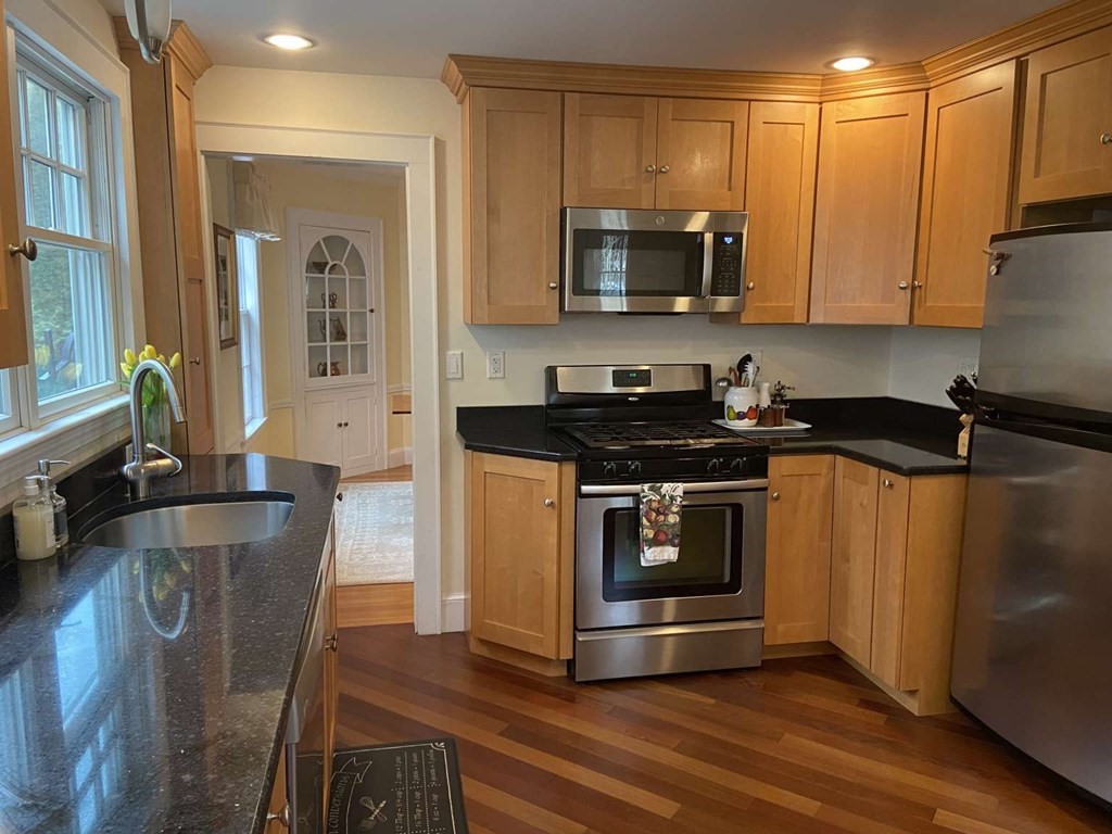 52 Governor Long Road Hingham, MA 02043 - Photo 4 of 19 a kitchen with granite countertop a stove and a microwave
