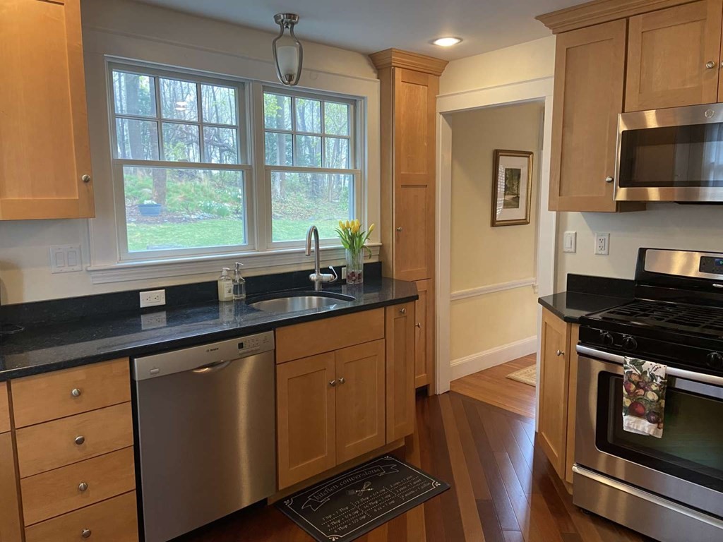 52 Governor Long Road Hingham, MA 02043 - Photo 5 of 19 a kitchen with granite countertop a stove a sink and wooden cabinets