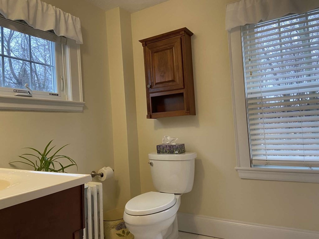 52 Governor Long Road Hingham, MA 02043 - Photo 10 of 19 a bathroom with a toilet sink and mirror