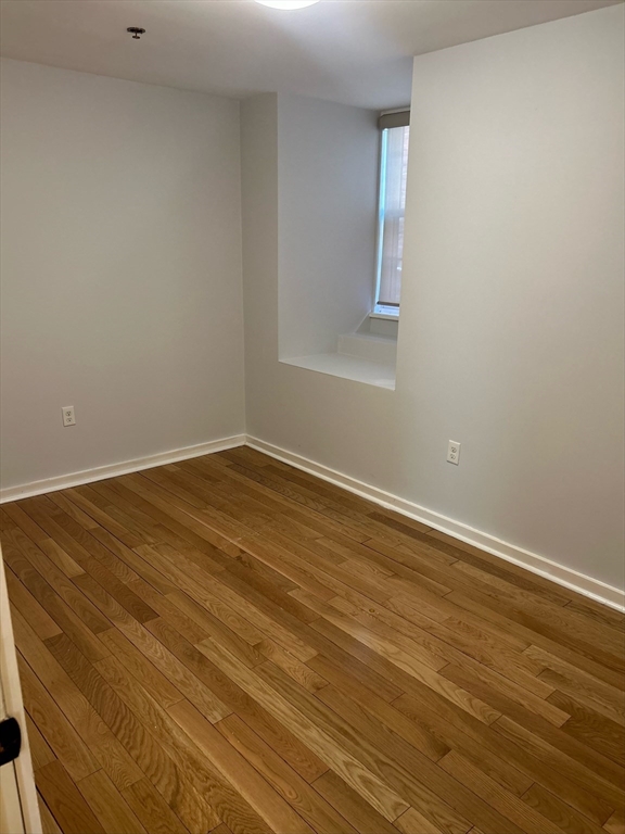 10 Linwood Street, Unit 1 Boston, MA 02119 - Photo 5 of 11 a view of an empty room with wooden floor