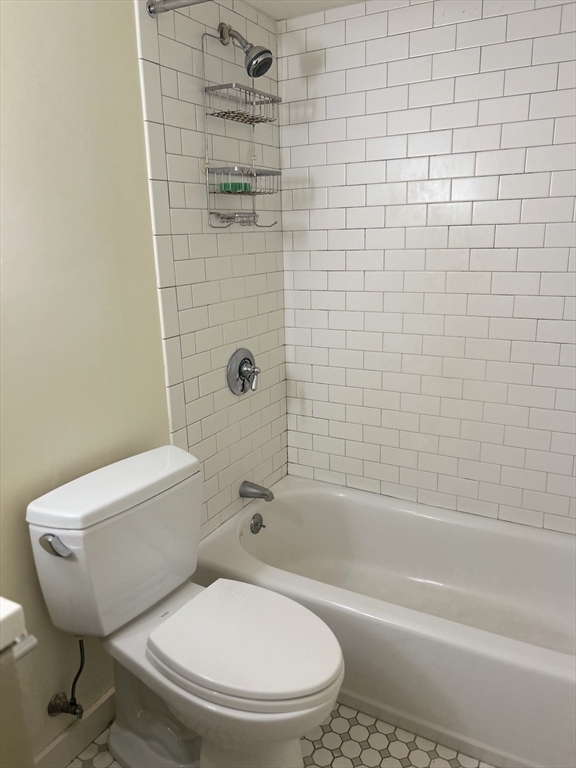 10 Linwood Street, Unit 1 Boston, MA 02119 - Photo 8 of 11 a white toilet and tub sitting next to a bathroom sink