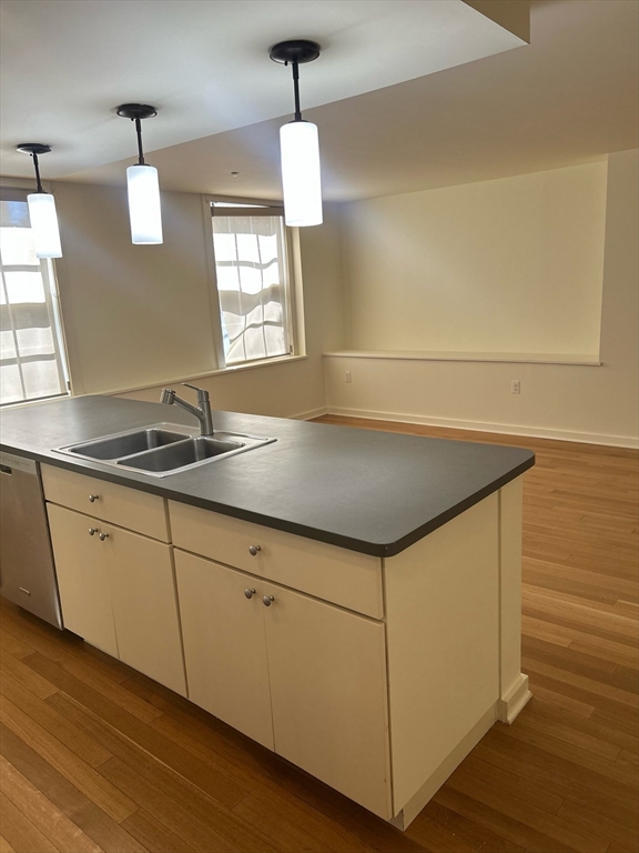 10 Linwood Street, Unit 1 Boston, MA 02119 - Photo 10 of 11 a kitchen with stainless steel appliances granite countertop a sink and a stove
