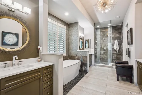 a bathroom with a sink a large mirror and a bathtub