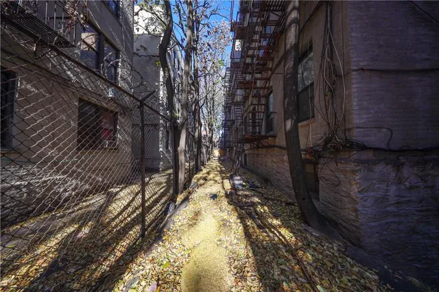 a front view of a residential apartment building with a yard