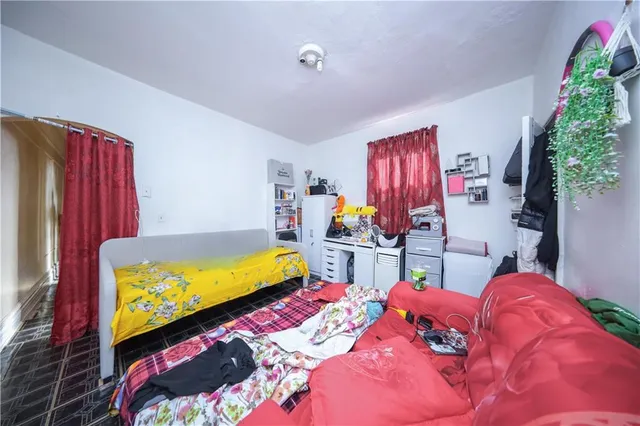 a bedroom with a bed and a painting on the wall