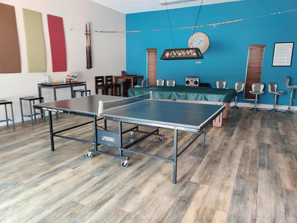 a room with table chairs and wooden floor