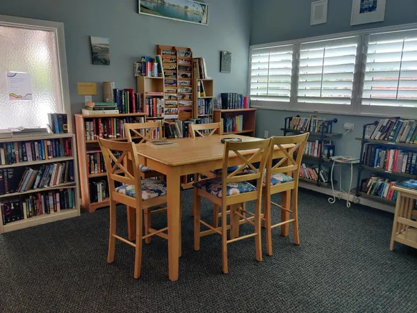 a dining room with furniture and a book shelf