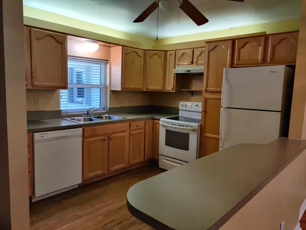 a kitchen with stainless steel appliances granite countertop a stove a refrigerator and a sink