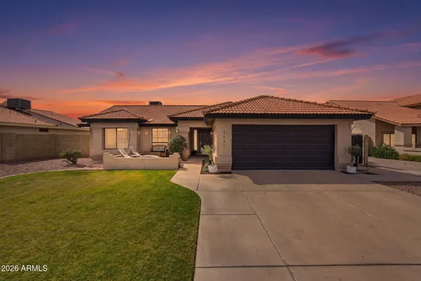 a front view of a house with yard fire pit and outdoor seating