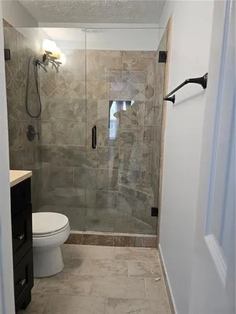 a bathroom with a shower and a toilet