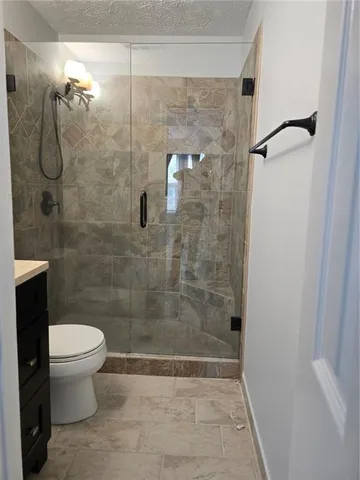 a bathroom with a shower and a toilet