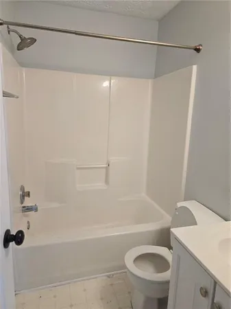 a bathroom with a shower a toilet and a sink