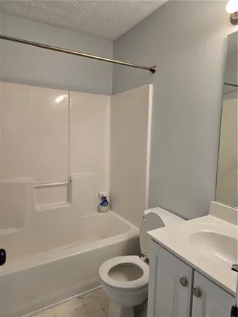 a bathroom with a sink a toilet and a bathtub