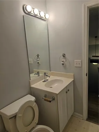 a bathroom with a toilet sink and mirror