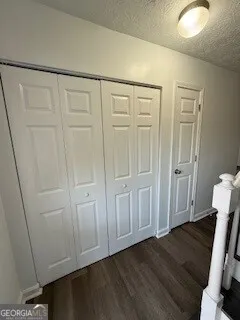 a view of a closet area with hardwood floor