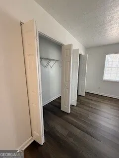 an empty room with wooden floor and closet