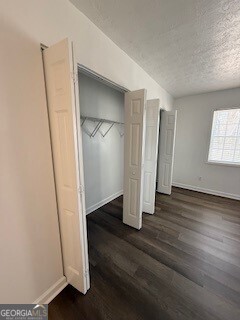 122 Saine Drive Southwest, Unit 307 Marietta, GA 30008 - Photo 17 of 22 an empty room with wooden floor and closet