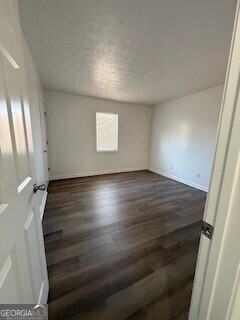 122 Saine Drive Southwest, Unit 307 Marietta, GA 30008 - Photo 3 of 22 an empty room with wooden floor and windows